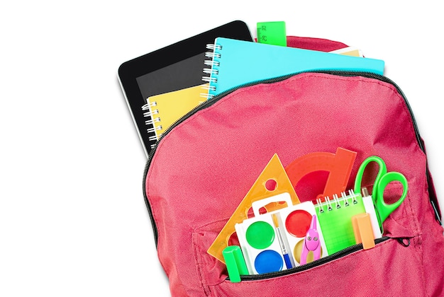 Part of red backpack with school supplies on white isolated background