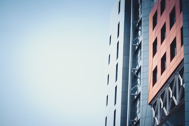 Part of the red blue facade urban buildings and sky. Background for text