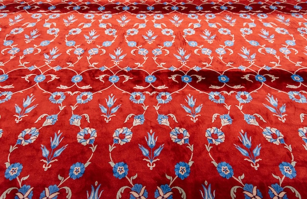 Part of red carpet or rug in muslim mosque.  Prayer mat in the Blue Mosque in Istanbul