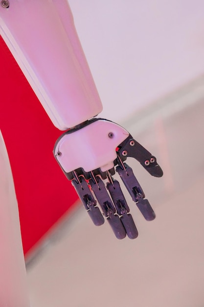 Part of the robot on a red background robot puts his hand forward