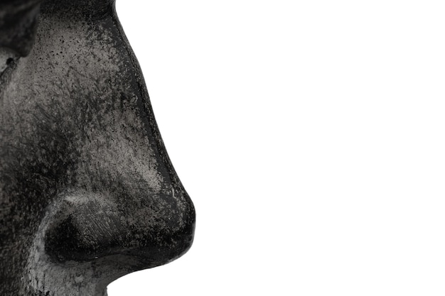 Part of the sculpture b is a fragment of a face nose in profile isolated on a white background