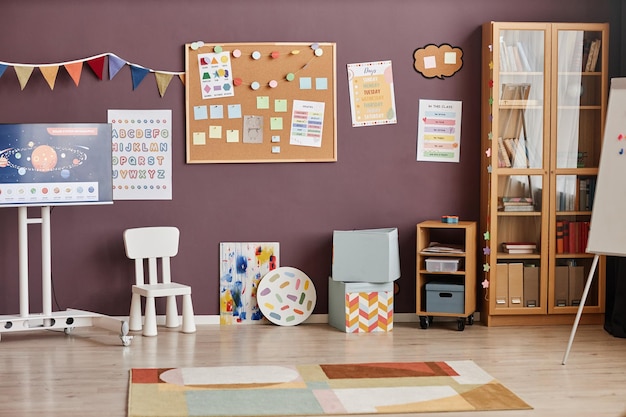 Photo part of spacious classroom of modern nursery school equipped with variety of supplies for educationa