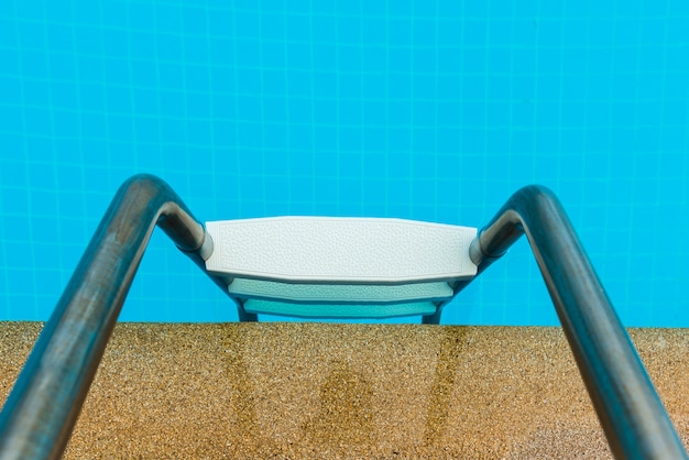 Part of swimming pool with ladder 