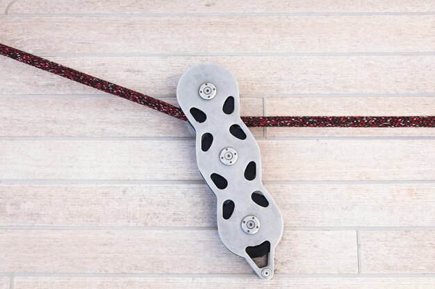 Part of the teak deck of a sailing yacht with fasteners on it for fixing ropes