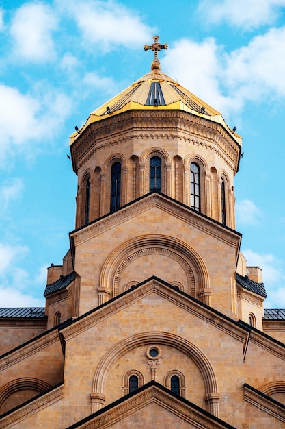 Part of Tsminda Sameba Holy Trinity Church in Tbilisi Georgia on a sunny day against a blue sky