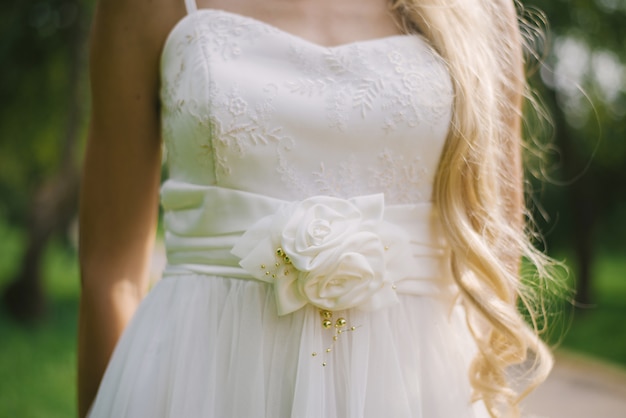 Part of the wedding dress on the bride, a belt with fabric roses on it