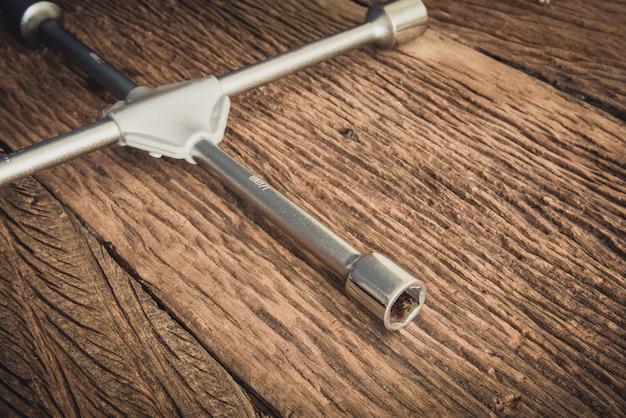 part of Wheel wrench on wooden background