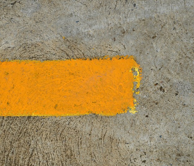 part of yellow arrow on the road