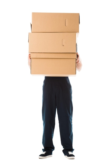 Partial view of delivery man hiding behind cardboard boxes isolated on white