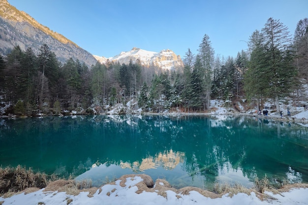 Partial view of the snowy Blausee lake in Switzerland