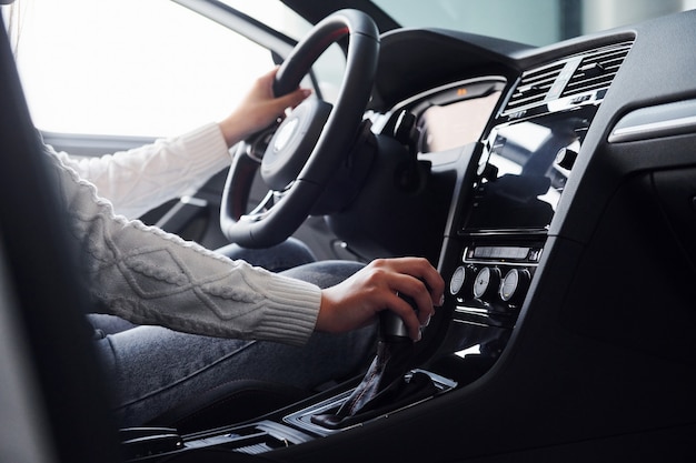 Particle view of man in formal wear that riding brand new car.