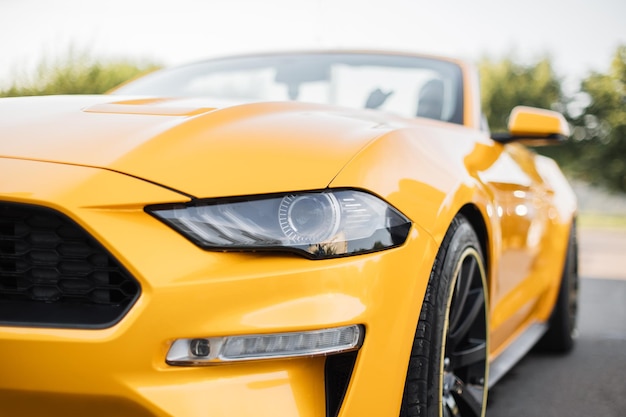 Particle view of yellow brand new modern luxury sport car parked outdoors