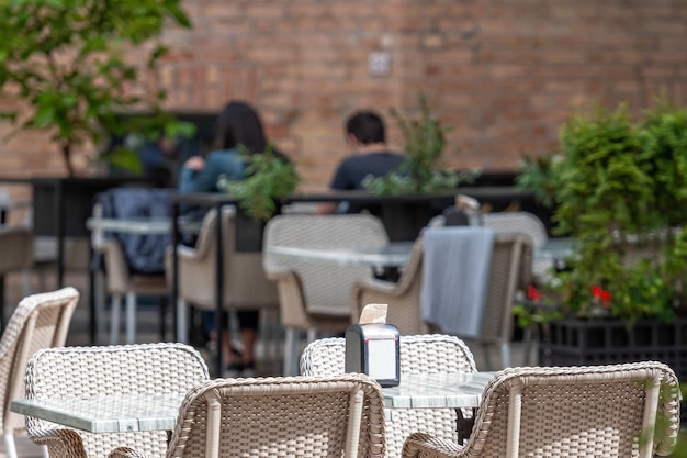 Photo partly empty street cafe table close-up pandemic impact on business concept