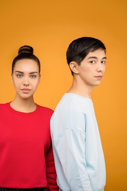 the partner making together a pose with orange background