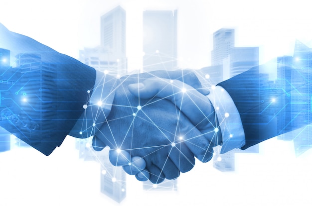 Partnership - business man shaking hands with effect digital network link connection graphic diagram, digital global technology with cityscape background