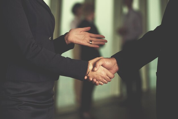 partnership concept with senior  business man and woman make hand shake and take agreement in modern office interior