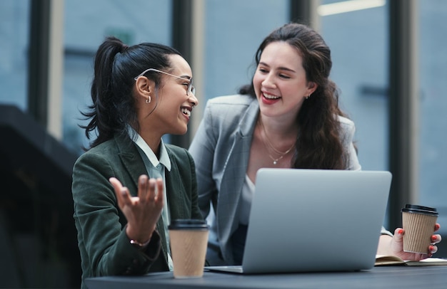 The partnership to outperform any other Shot of two young businesswomen using a laptop during a meeting at a coffee shop