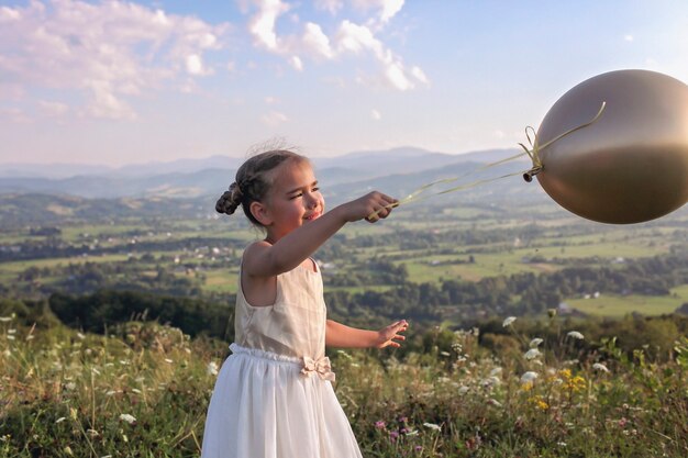 Party after lockdown girl dancing alone with air balloons on the top of the mountains new normal