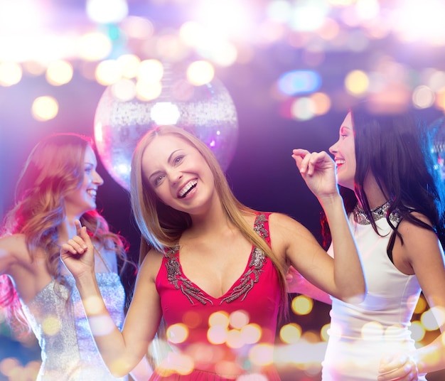 Party, celebration, holidays, nightlife and people concept - happy women dancing at night club