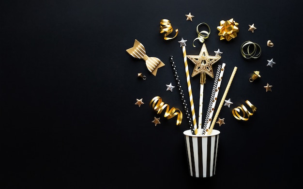 Party and celebration with golden prop and ornament on dark color background.Flat lay design