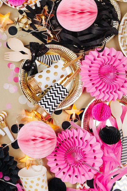 Party decoration background. Gold, black and pink color. Flat lay, top view