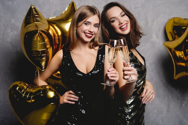 Party Fun. Beautiful Girls Celebrating New Year. Portrait Of Gorgeous Smiling Young Women Enjoying Party Celebration, Having Fun Together. High Quality Image.