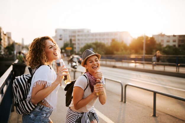 Party girls singing and having fun in the city.