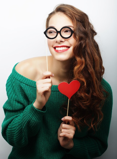 Party image Playful young woman holding a party glasses