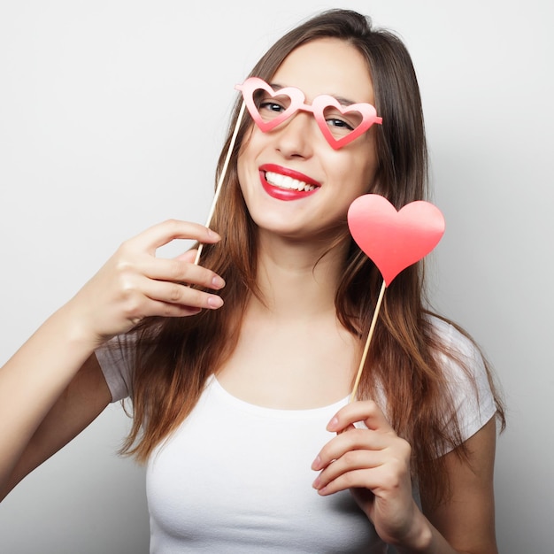 Party image Playful young woman holding a party heart