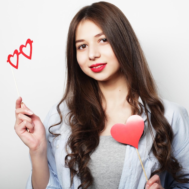 Party image Playful young woman holding a party heart