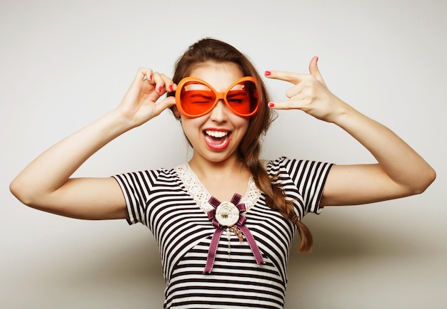 Party image Playful young woman with big party glasses and crown Ready for good time