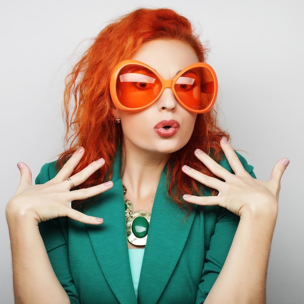 Party image. Playful young women holding a party glasses. Ready for good time.