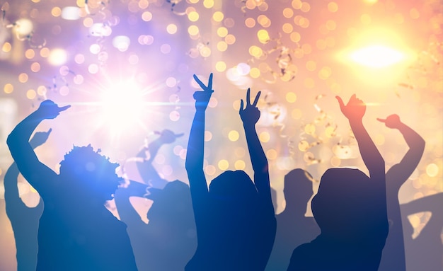 party people dancing in night club many party people dancing bright lights confetti flying everywhere nightclub event hands festival party people club concert