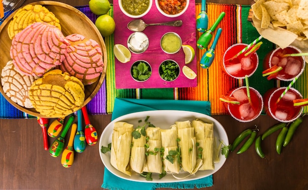 Party table with tamales, strawberry margaritas and pan dulche bread.