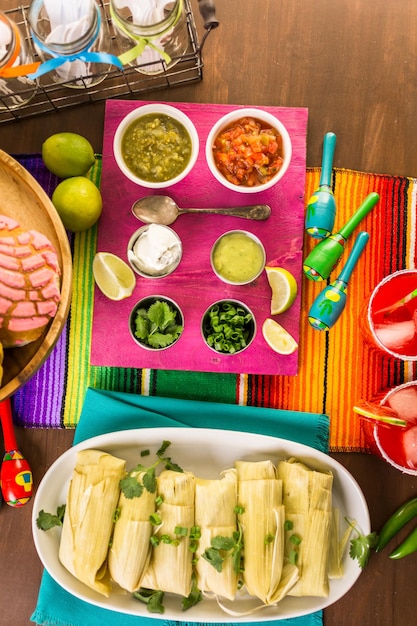 Party table with tamales, strawberry margaritas and pan dulche bread.