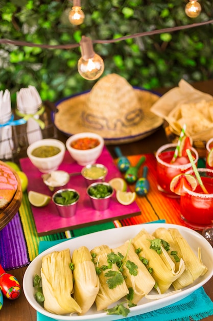 Party table with tamales, strawberry margaritas and pan dulche bread.