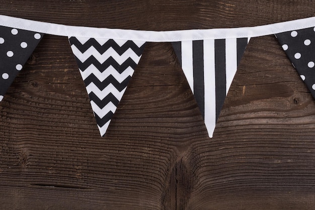 Party triangle bunting flags hanging on the rope On the old wooden background