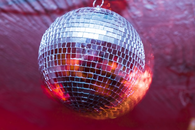 Party with disco ball with red lights