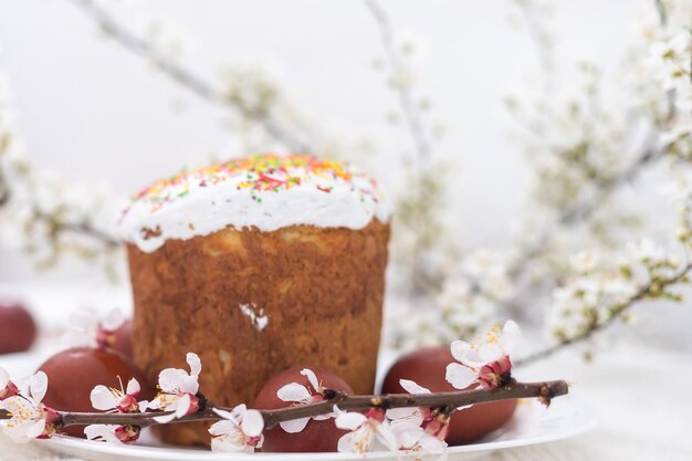 Pasen achtergrond met gekleurde eieren, gekleurde paaseieren en bloeiende takken. Pasen samenstelling. Paascake.