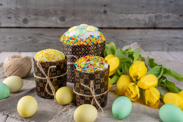 Pasen-cake, geschilderde eieren met tulpen op een houten oude rustieke achtergrond.