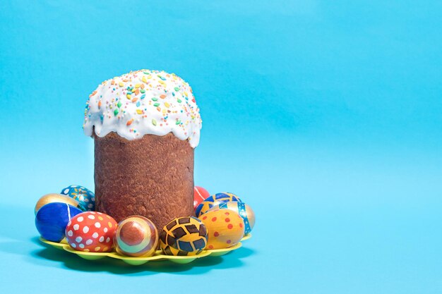 Paska Easter cake and painted eggs of pysanka on a blue background