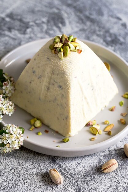 Paskha and kulich with pistachios. Traditional Russian Orthodox Easter Quark Dessert Curd. Easter food background. Traditional cottage cheese cake