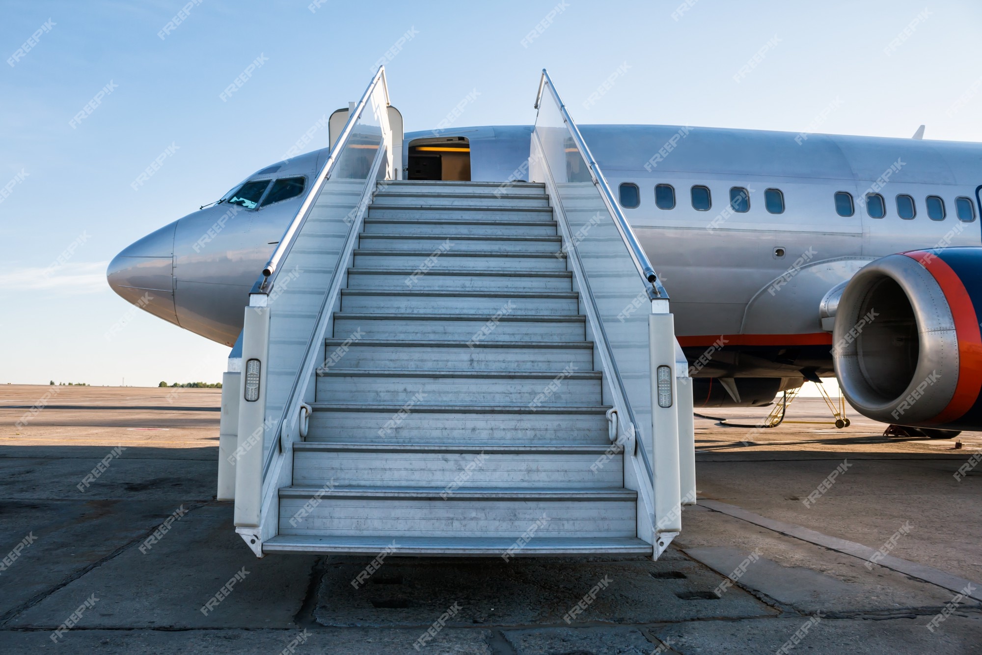 Premium Photo | Passenger aircraft with a boarding ramp on the airport apron