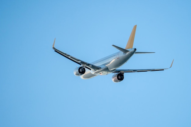 Passenger airplane flight in blue sky bottom view travel concept