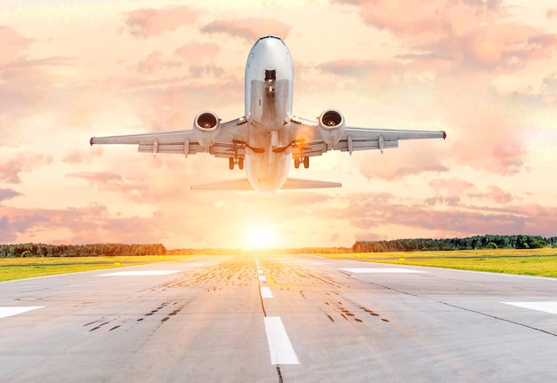 Passenger airplane landing and missed approach go around at sunset on a runway