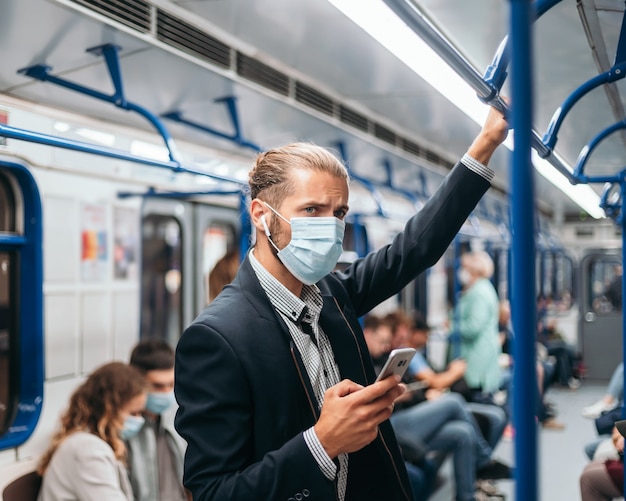 passenger in a face mask while reading a text