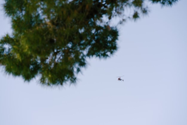 Passenger helicopter flies in the sky among the clouds