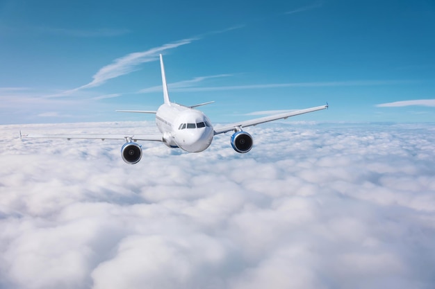 Passenger plane flies over overcast on a sunny day