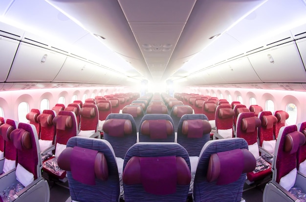 Passenger seat Interior of airplane with passengers sitting on seats