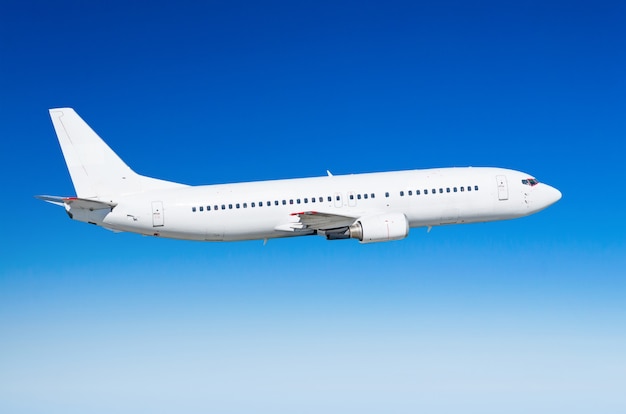 passenger white airplane on the side view, flies on a flight level sky.